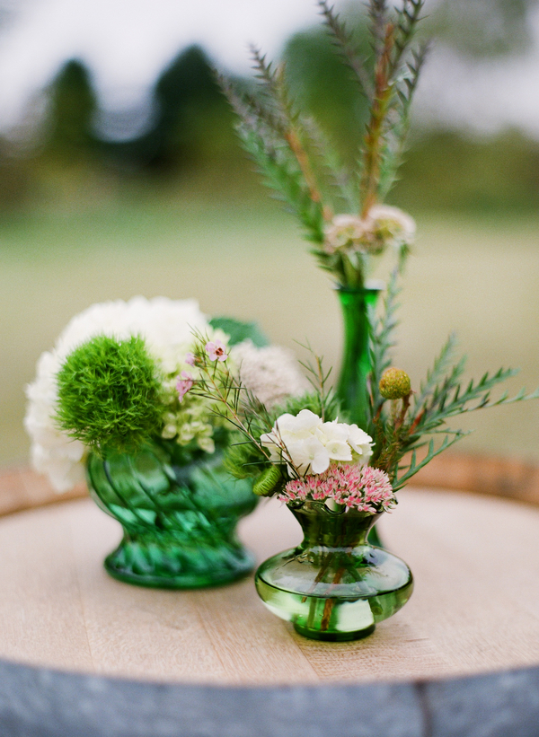 green colored glass centerpiece rustic wedding centerpiece wildflowers